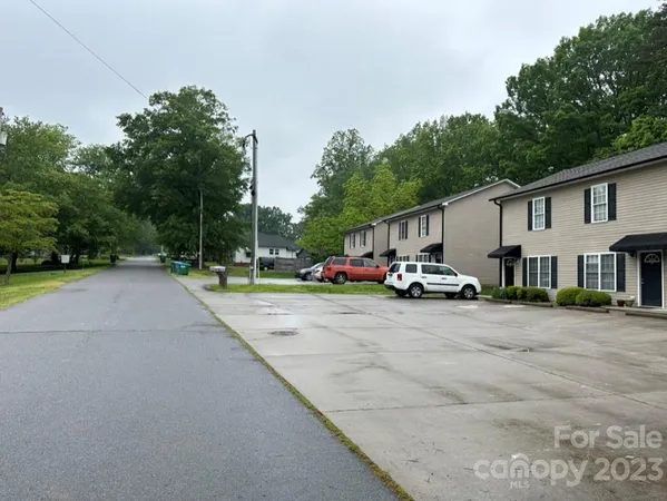 a swimming pool with yard in the background