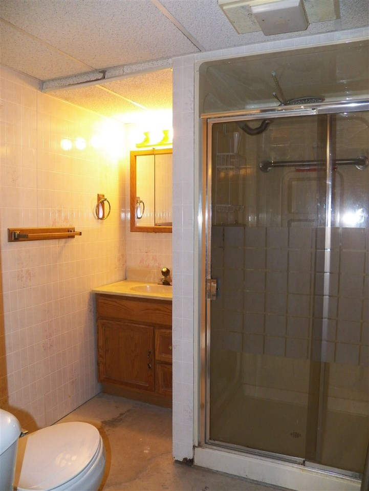 2325 Forest View Road Rockford, IL 61108 - Photo 16 of 17 a bathroom with a granite countertop sink toilet and shower