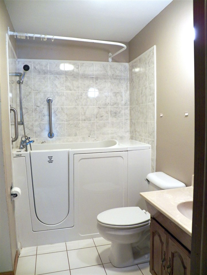 2325 Forest View Road Rockford, IL 61108 - Photo 10 of 17 a bathroom with a granite countertop toilet sink and shower