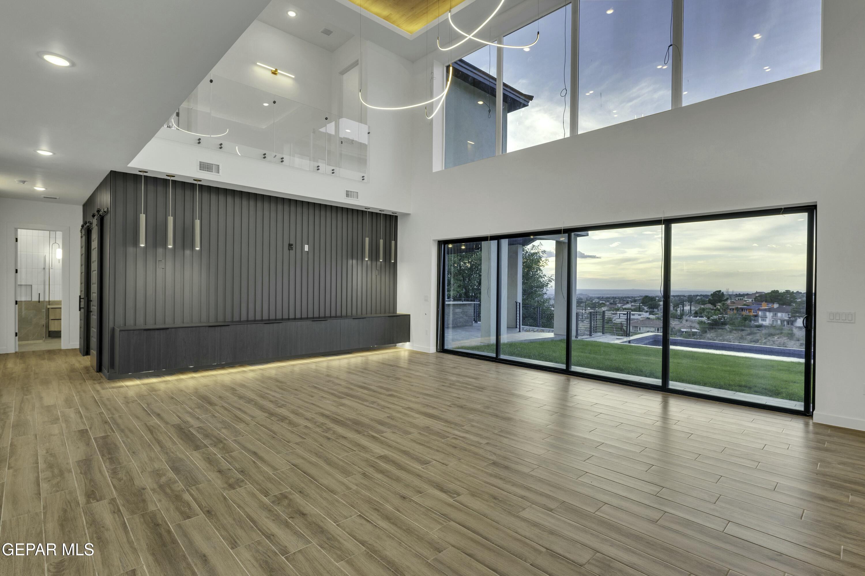 884 West Gate El Paso, TX 79932 - Photo 4 of 10 a view of an empty room with wooden floor and a window