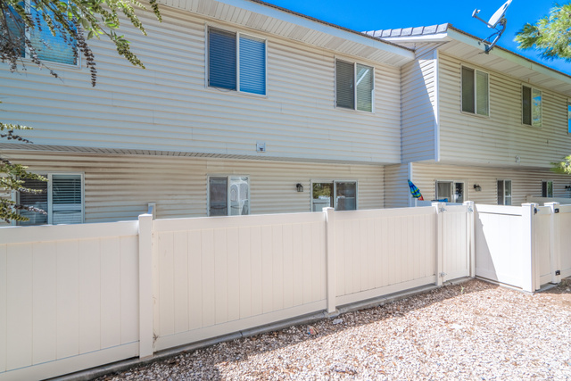 1735 West 540 North, Unit 1805 St. George, UT 84770 - Photo 32 of 64 Cream-colored vinyl siding exterior with multiple windows and sliding glass doors