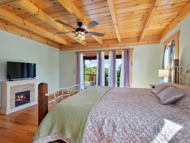 a bedroom with a large bed and a flat screen tv