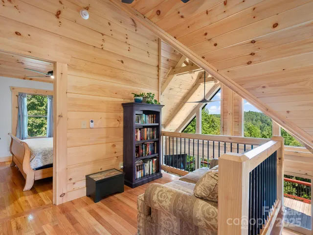 a bedroom with furniture a window and a wooden floor