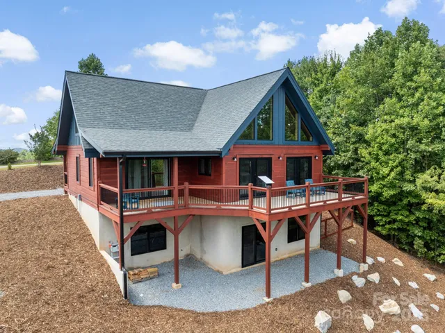 a view of house with roof deck and seating space