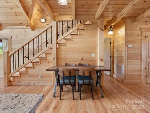 a view of a hallway with dining room and wooden floor