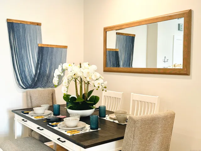 a living room with furniture and wall painting