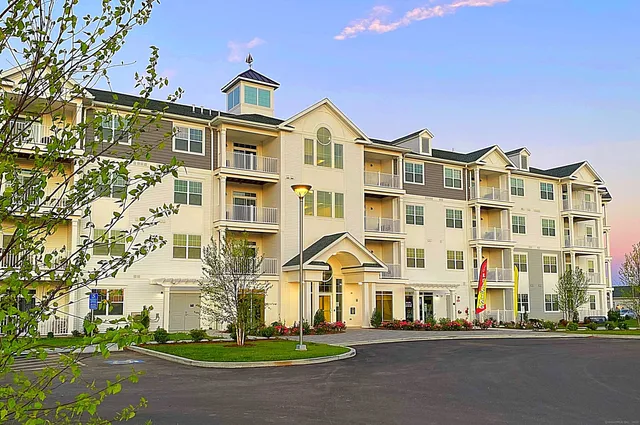 a building with swimming pool and tall buildings in the background