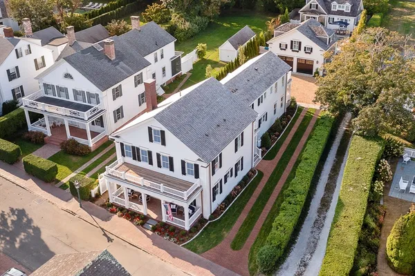 an aerial view of a house with a garden and trees