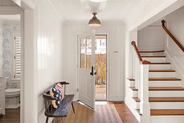 a view of a hallway with wooden floor and workspace
