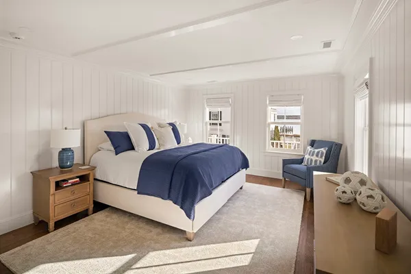 a spacious bedroom with a bed and glass windows