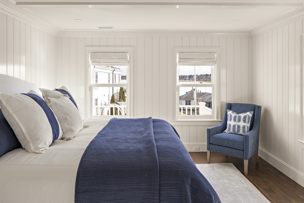 114 North Water Street Edgartown, MA 02539 - Photo 19 of 42 a spacious bedroom with a bed and chair