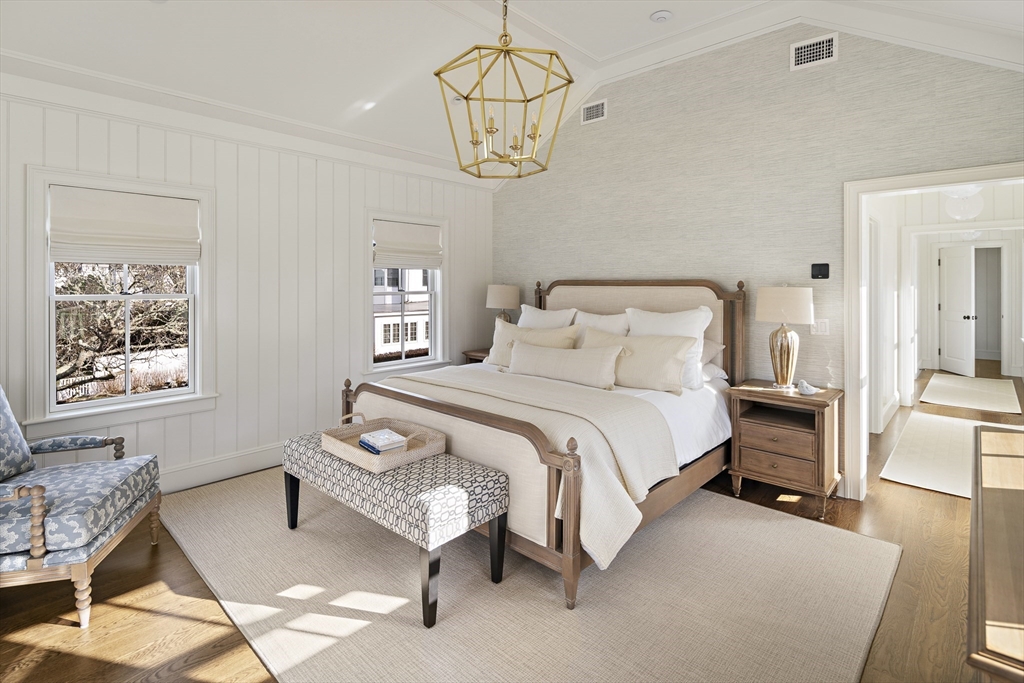 114 North Water Street Edgartown, MA 02539 - Photo 25 of 42 a bedroom with a bed and a chandelier