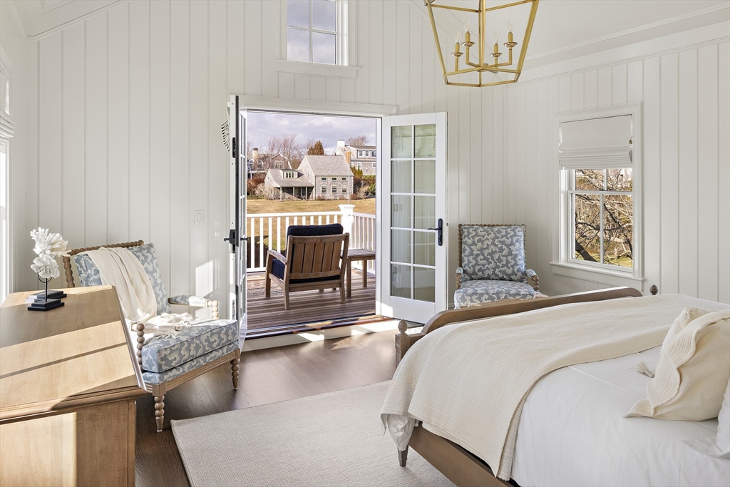 114 North Water Street Edgartown, MA 02539 - Photo 26 of 42 a bedroom with a bed and dresser with wooden floor