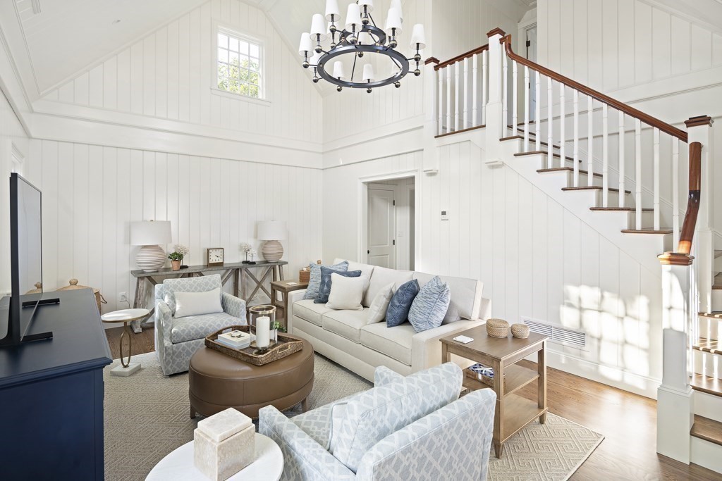 114 North Water Street Edgartown, MA 02539 - Photo 39 of 42 a living room with couches a fireplace and kitchen view with wooden floor