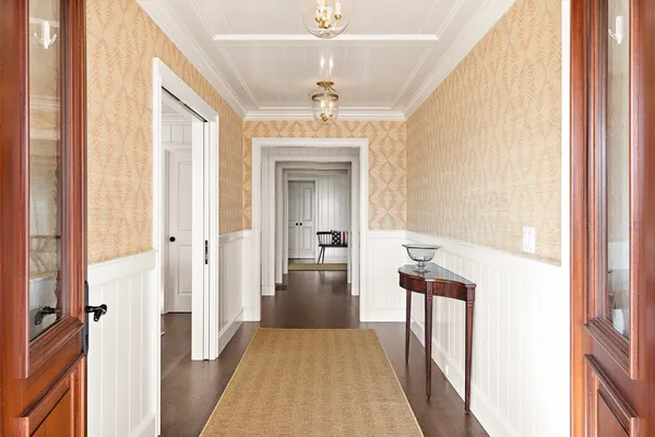 a view of a hallway view with wooden floor and staircase