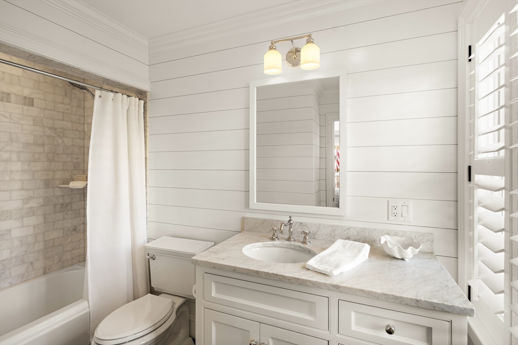 114 North Water Street Edgartown, MA 02539 - Photo 9 of 42 a bathroom with a granite countertop sink toilet and shower