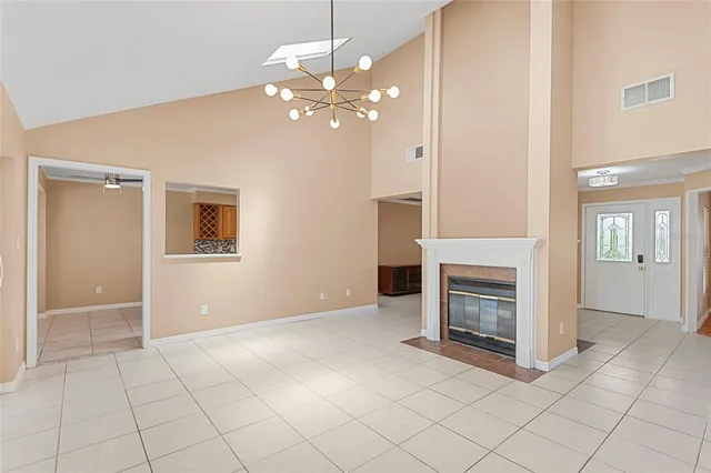 an empty room with fireplace and fan