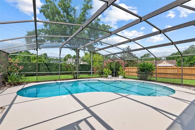 a view of a backyard with swimming pool