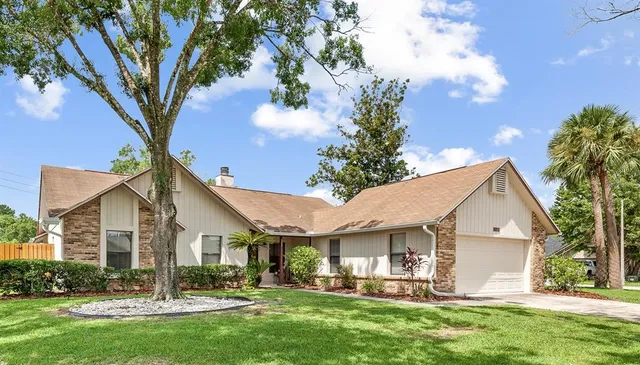 a front view of house with yard and green space