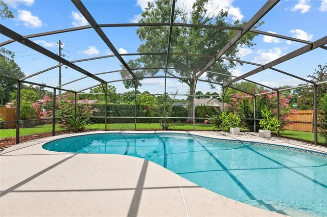 a view of a backyard with a swimming pool