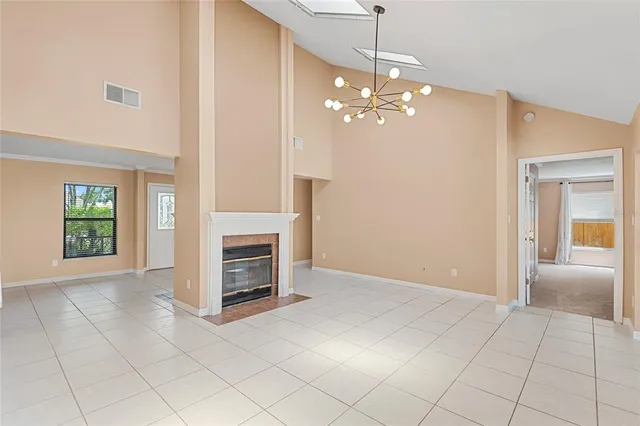 a view of a livingroom with a chandelier fan and fire place