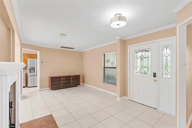 a view of an empty room with cabinet and fire place