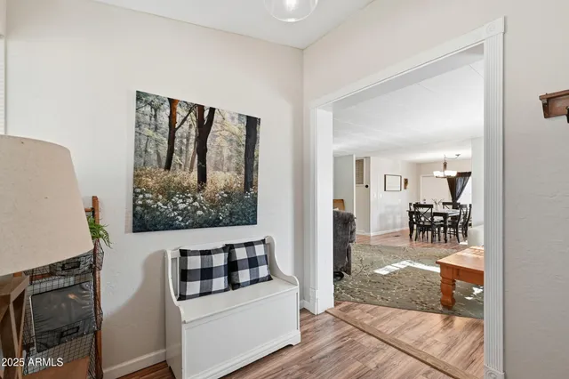 a view of a livingroom with wooden floor and furniture