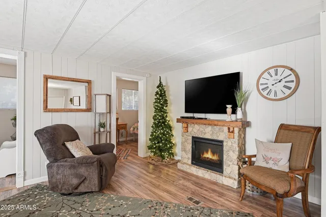 a living room with furniture a flat screen tv and a fireplace