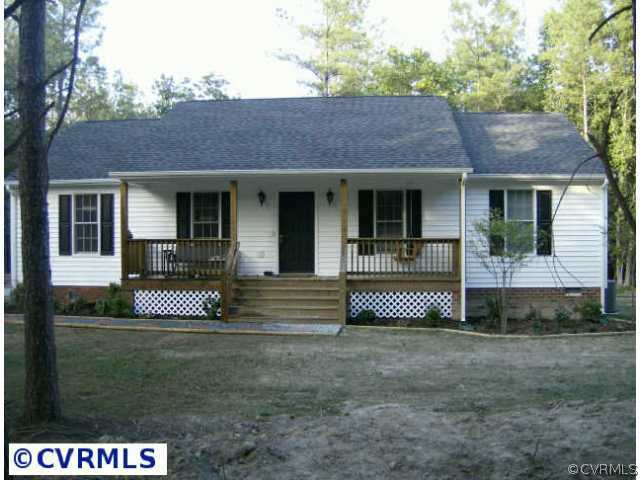 4198 Custis Millpond Road West Point, VA 23181 - Photo 3 of 10 a front view of a house with garage