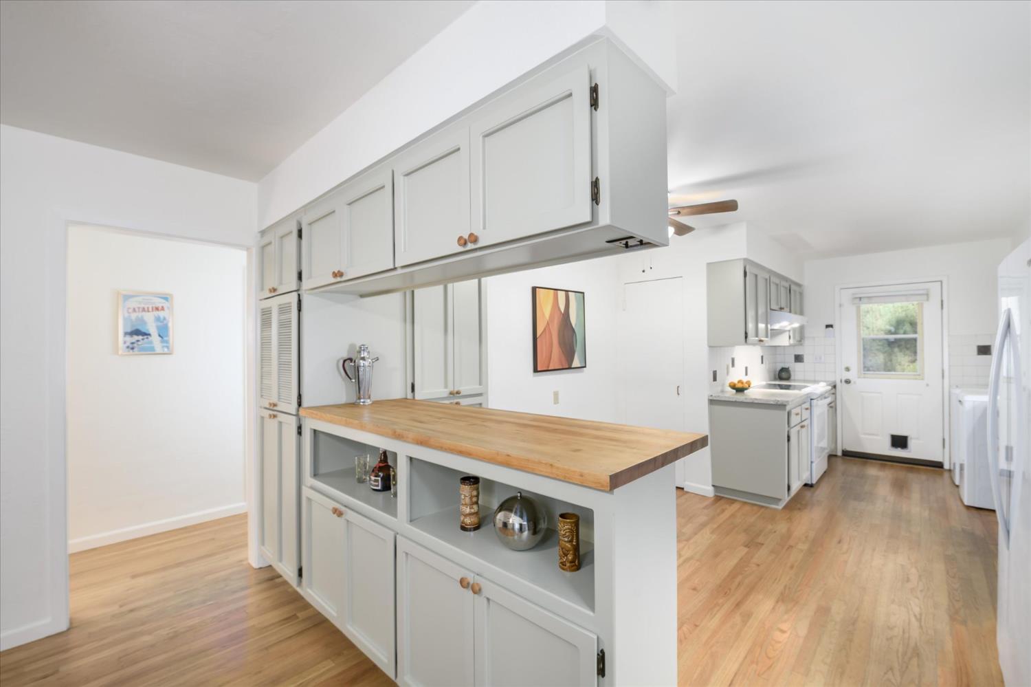 3166 Cedar Ravine Road Placerville, CA 95667 - Photo 4 of 29 a kitchen that has a lot of cabinets a sink and wooden floor