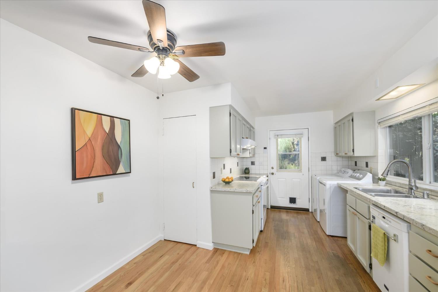 3166 Cedar Ravine Road Placerville, CA 95667 - Photo 5 of 29 a kitchen with a sink cabinets wooden floor and a large window