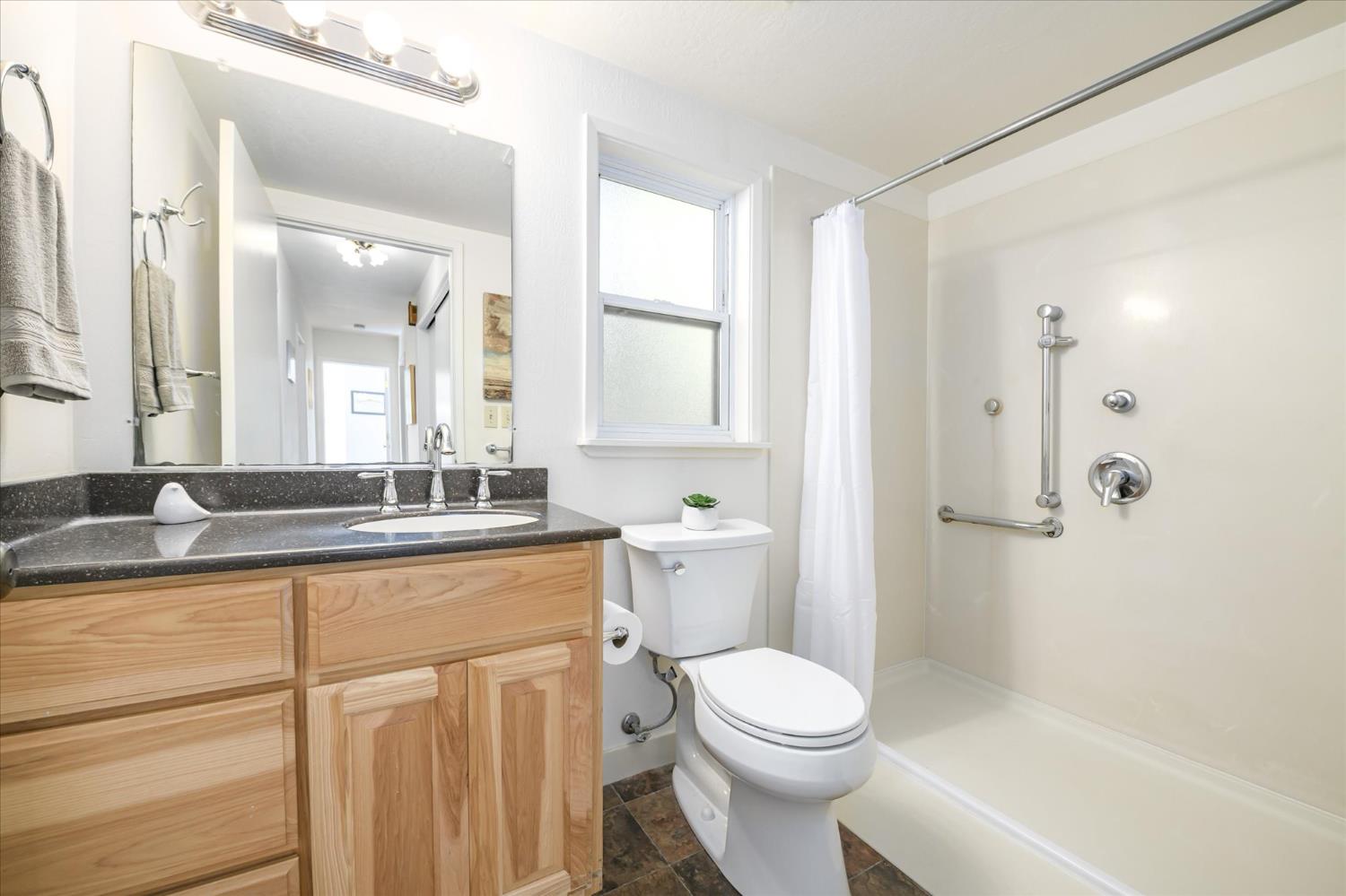 3166 Cedar Ravine Road Placerville, CA 95667 - Photo 10 of 29 a bathroom with a granite countertop sink a toilet a mirror and shower