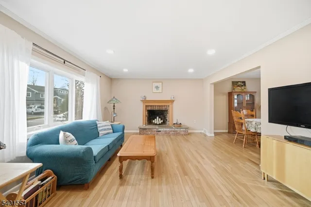 a view of a dining room with furniture wooden floor and a chandelier