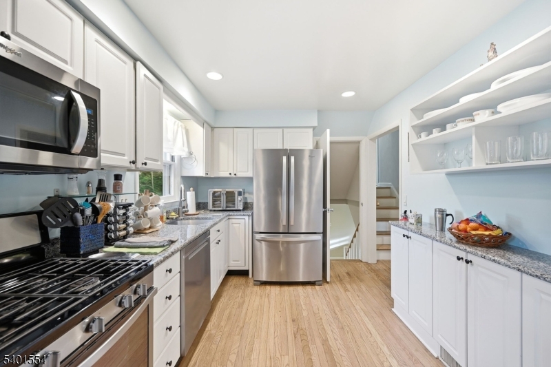 58 Dogwood Road Morristown, NJ 07960 - Photo 24 of 44 a kitchen with stainless steel appliances a refrigerator a sink a stove and cabinets