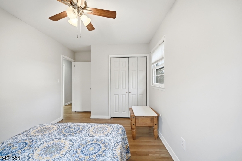 58 Dogwood Road Morristown, NJ 07960 - Photo 35 of 44 a bedroom with a bed and a chandelier