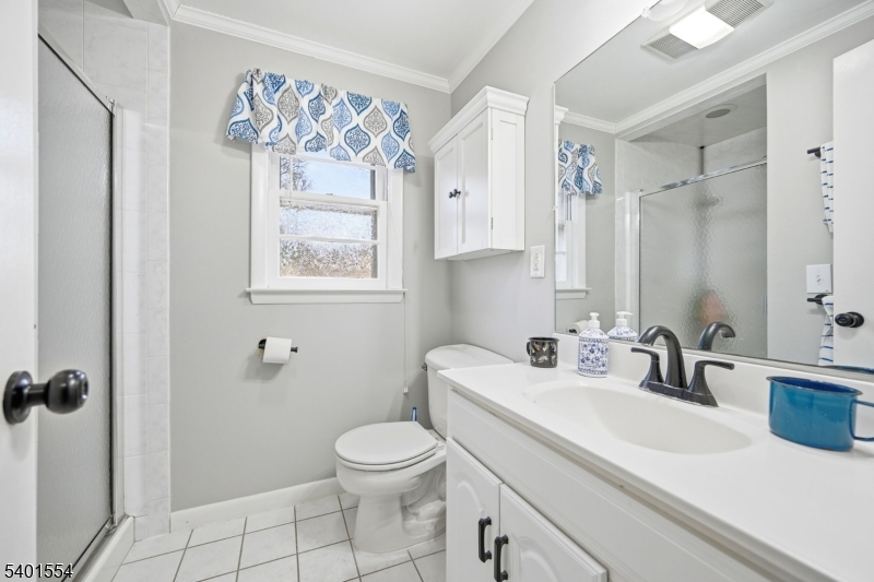 58 Dogwood Road Morristown, NJ 07960 - Photo 38 of 44 a bathroom with a sink mirror toilet and next to a window