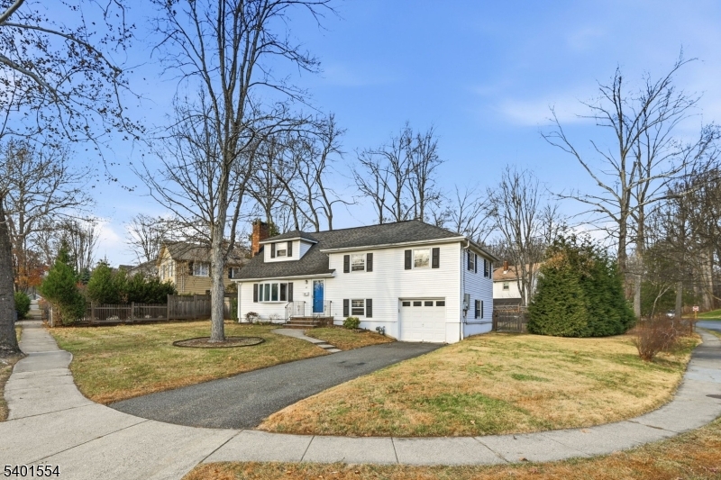 58 Dogwood Road Morristown, NJ 07960 - Photo 6 of 44 a view of a white house with a yard covered with snow