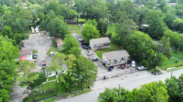an aerial view of a house with a yard and tree s