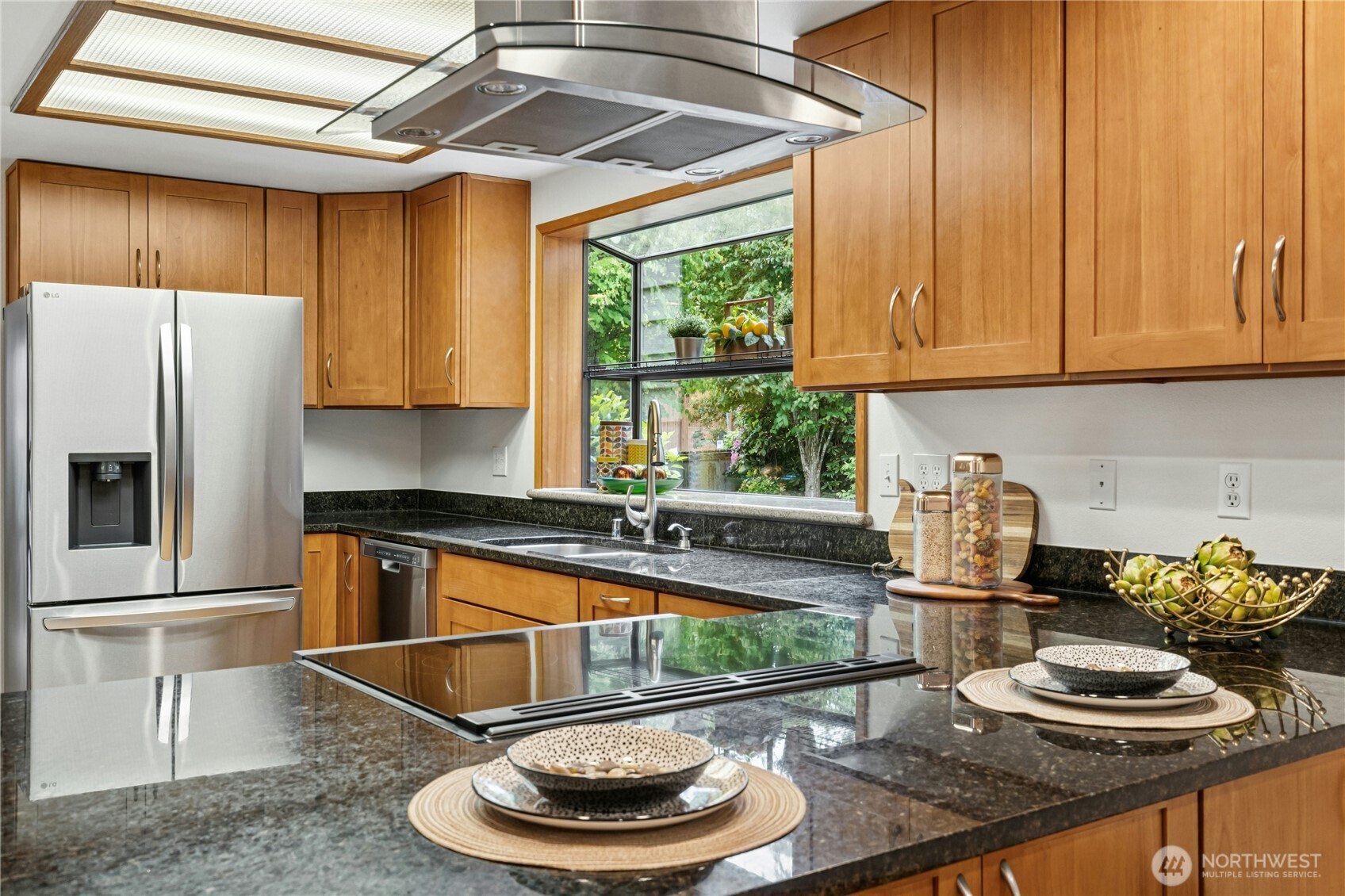 5211 103rd Street Southwest, Unit SW Mukilteo, WA 98275 - Photo 11 of 40 a kitchen with a sink a stove and a wooden cabinets