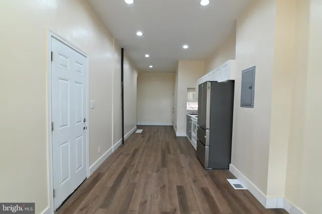 a view of a hallway with wooden floor