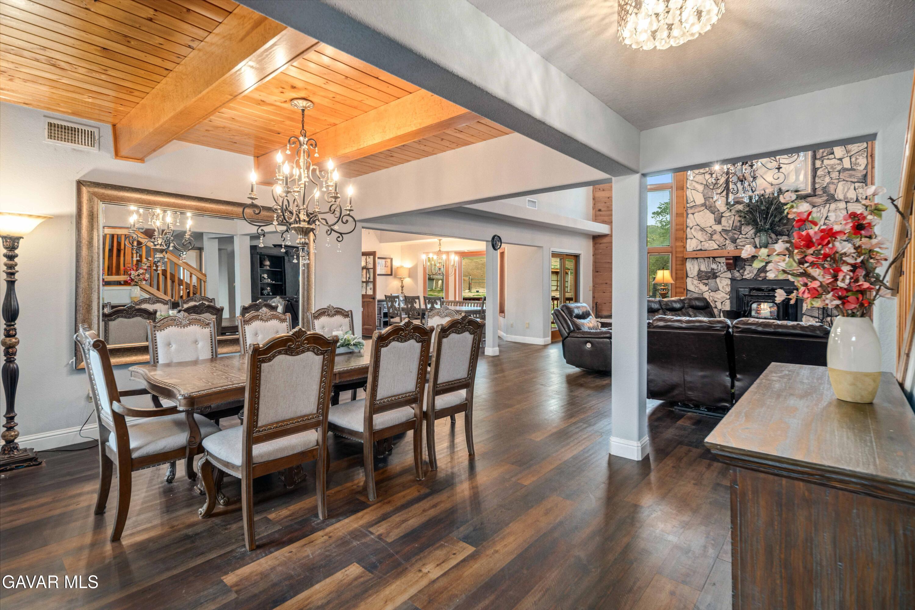 23800 Bertram Circle Tehachapi, CA 93561 - Photo 12 of 85 a view of a dining room with furniture a chandelier and wooden floor