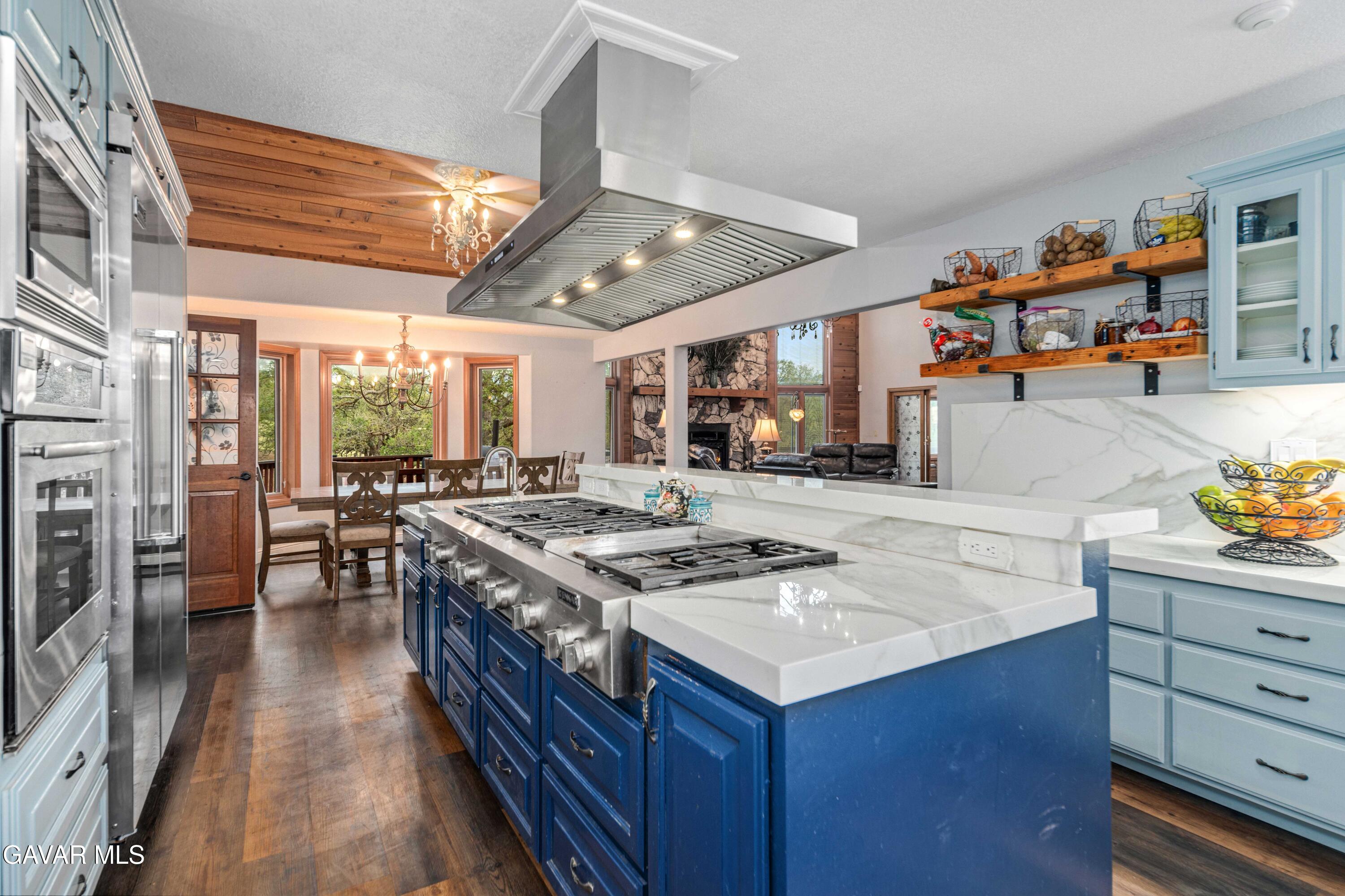 23800 Bertram Circle Tehachapi, CA 93561 - Photo 21 of 85 a kitchen with stainless steel appliances granite countertop a stove and a refrigerator
