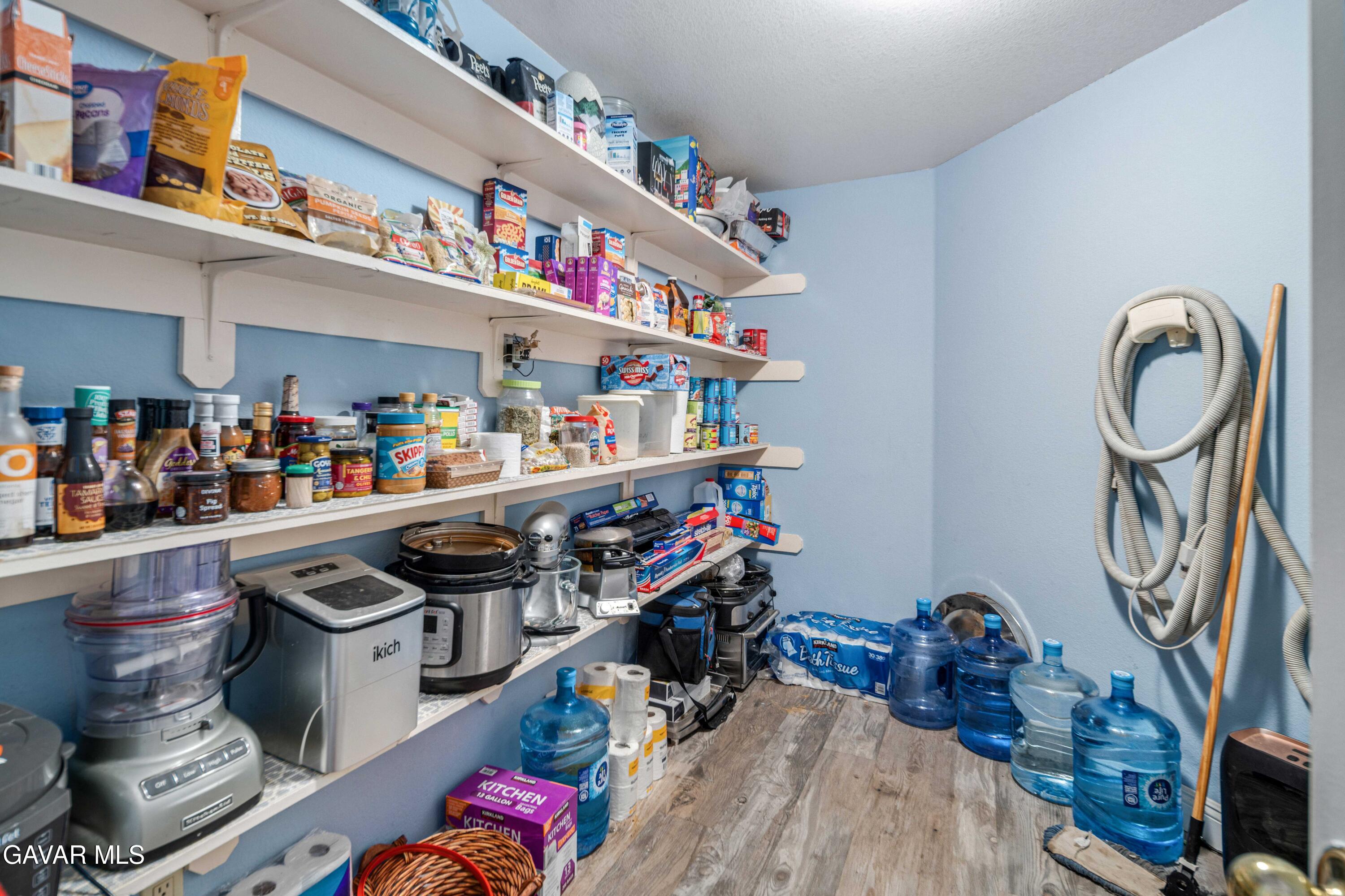 23800 Bertram Circle Tehachapi, CA 93561 - Photo 26 of 85 a kitchen with lots of clutter and cabinets