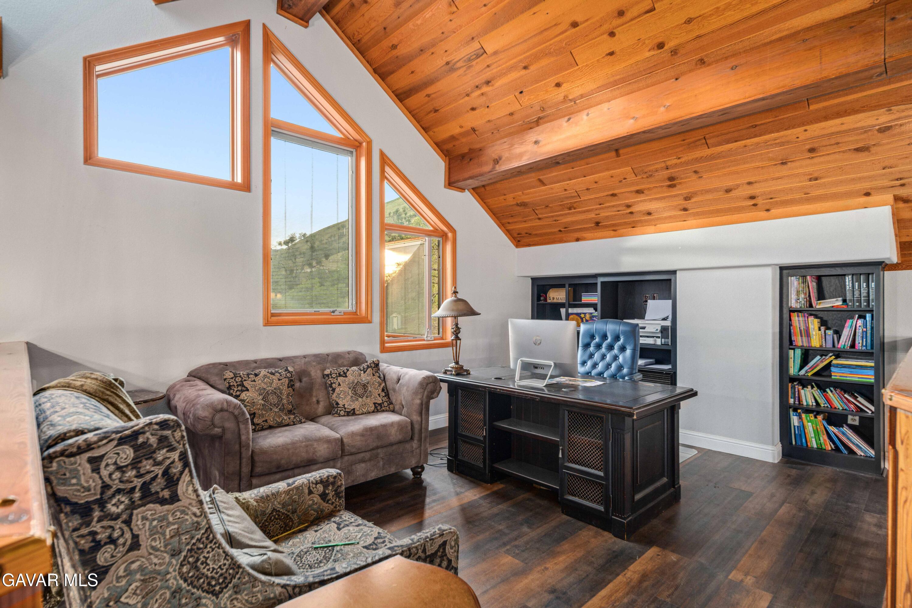 23800 Bertram Circle Tehachapi, CA 93561 - Photo 36 of 85 a living room with furniture a rug and a bookshelf