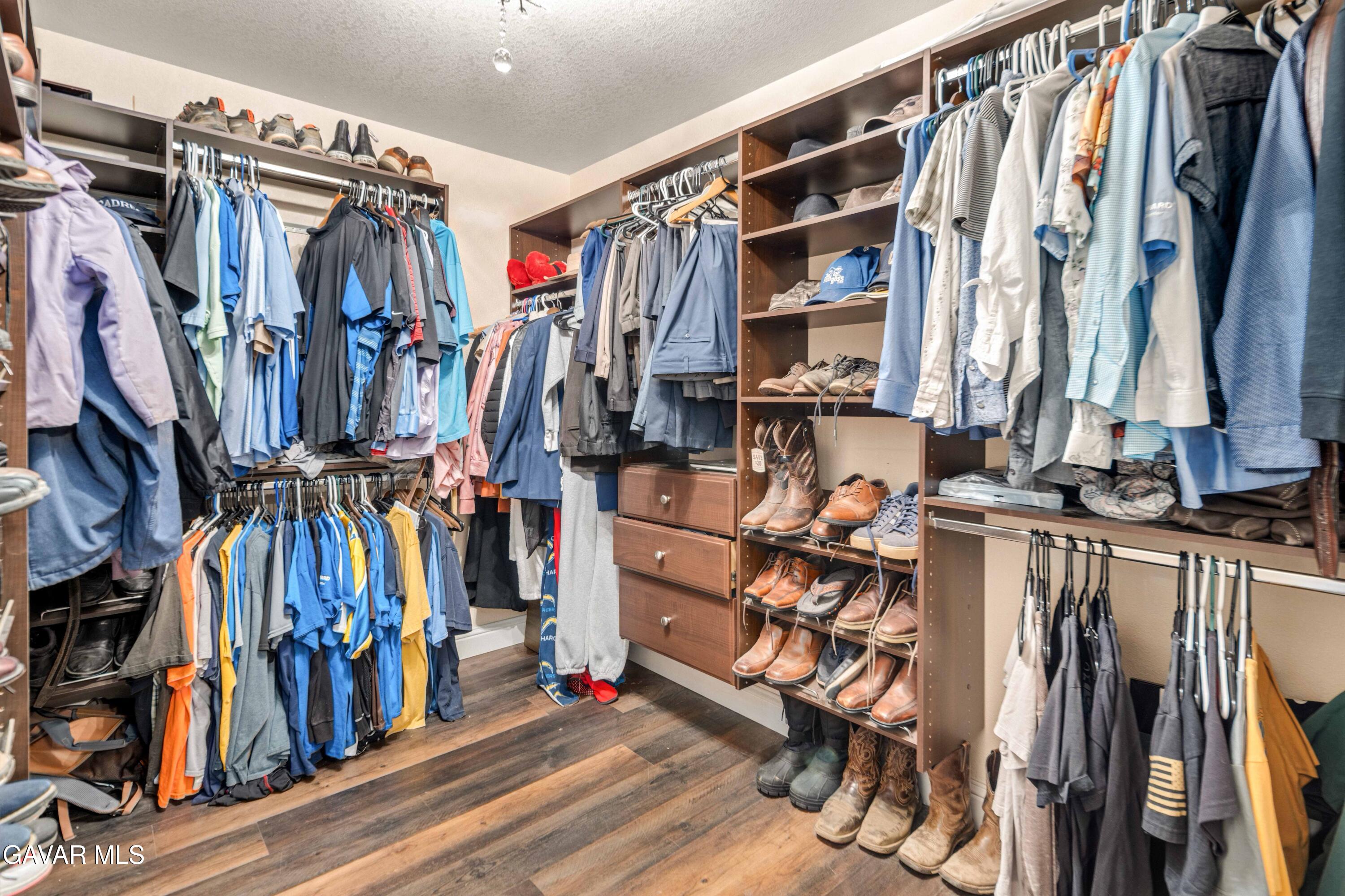 23800 Bertram Circle Tehachapi, CA 93561 - Photo 47 of 85 a view of walk in closet with clothes and shoes
