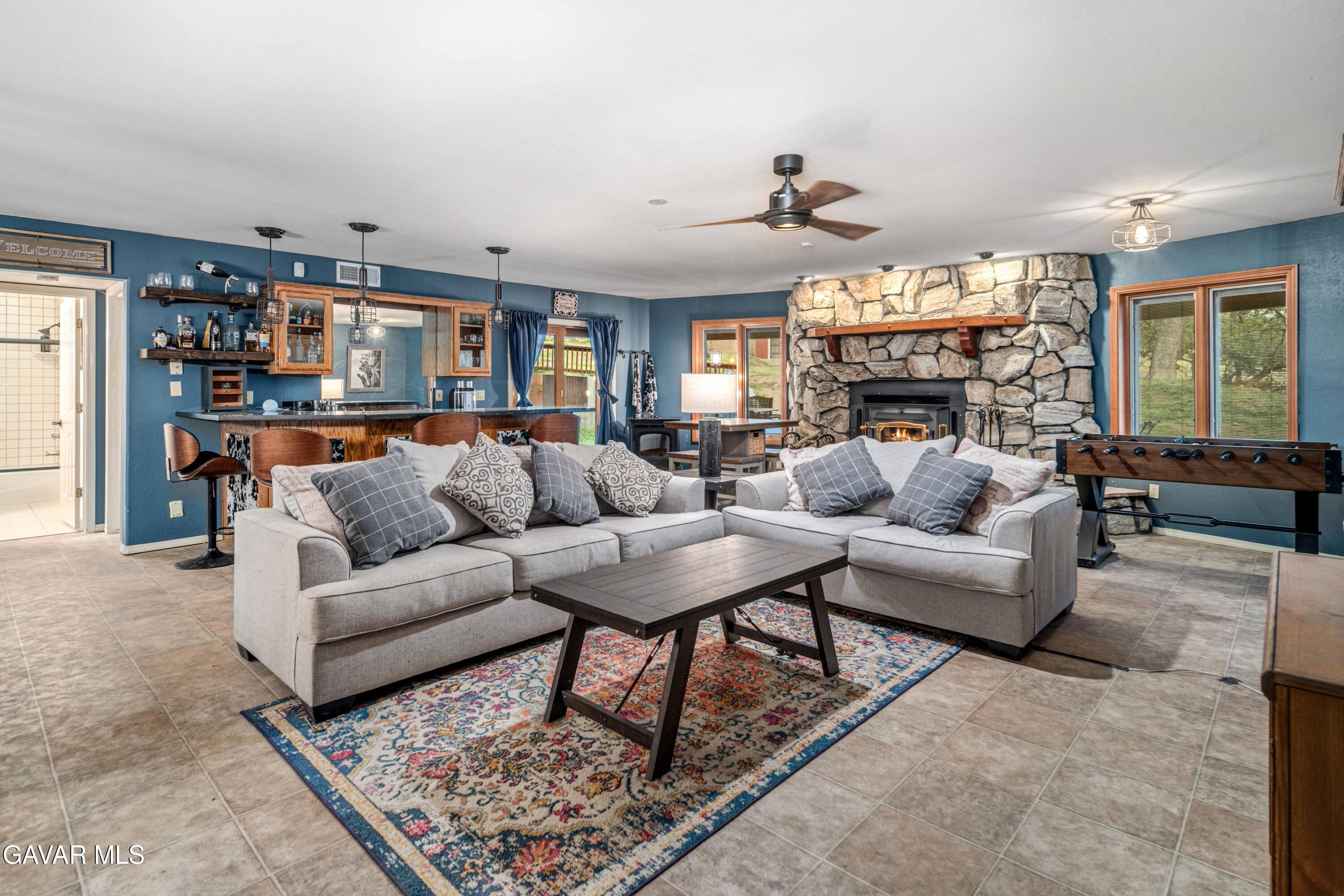 23800 Bertram Circle Tehachapi, CA 93561 - Photo 51 of 85 a living room with furniture a fireplace and a chandelier