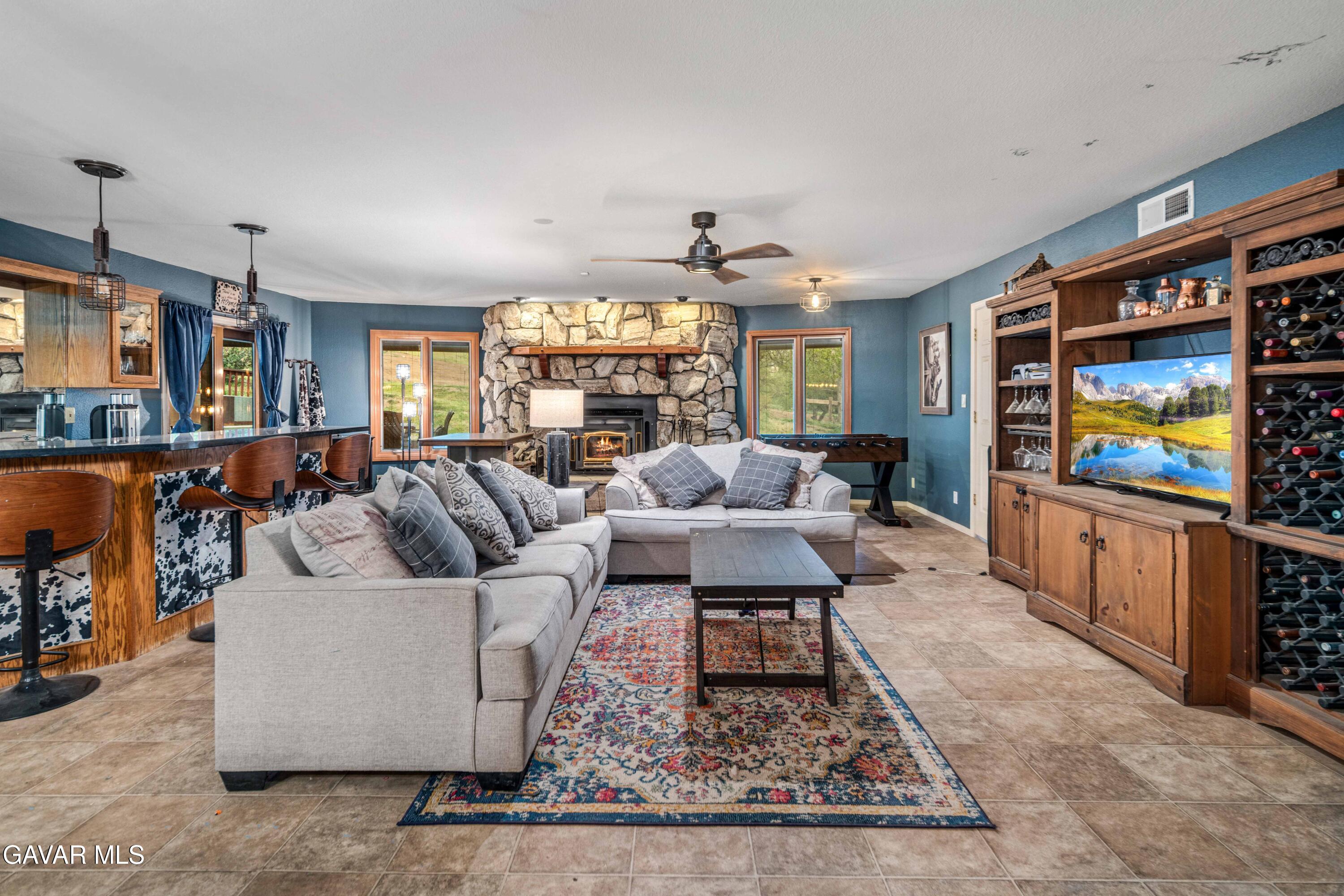 23800 Bertram Circle Tehachapi, CA 93561 - Photo 52 of 85 a living room with furniture and a flat screen tv