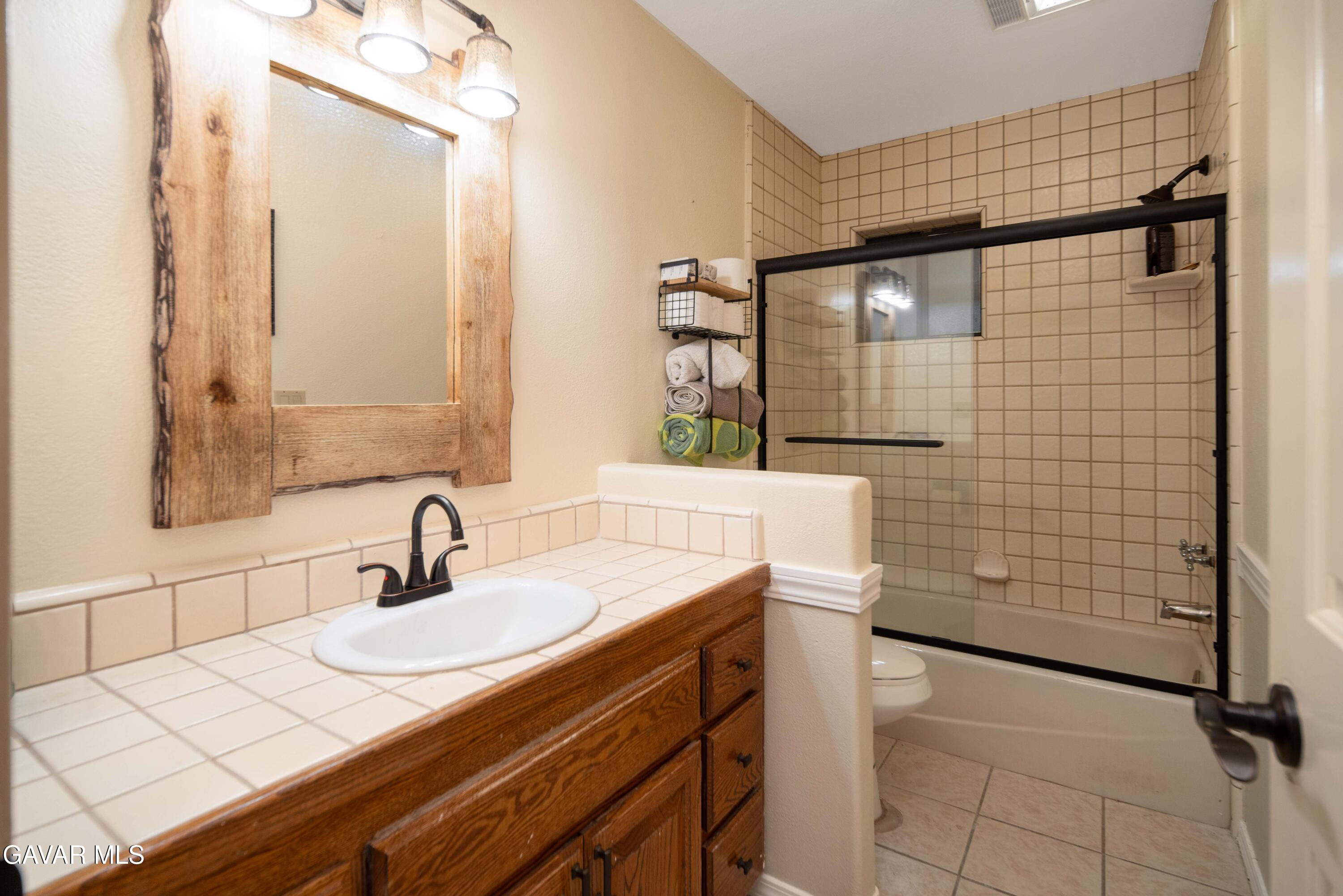 23800 Bertram Circle Tehachapi, CA 93561 - Photo 57 of 85 a bathroom with a sink and a mirror