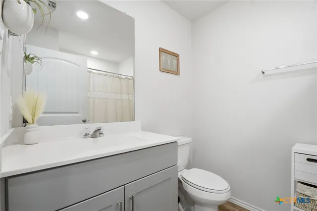 a bathroom with a sink toilet and a mirror