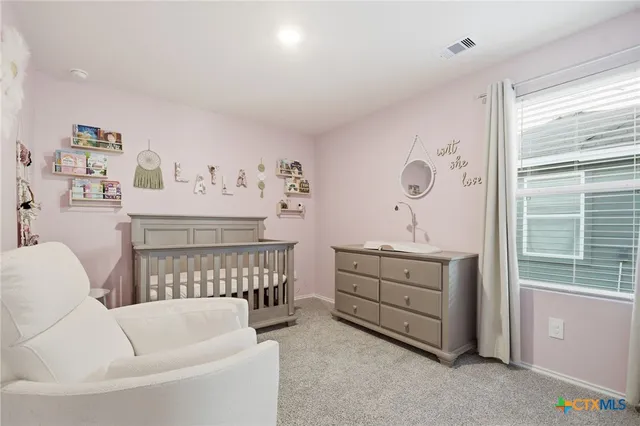 a bedroom with furniture and window